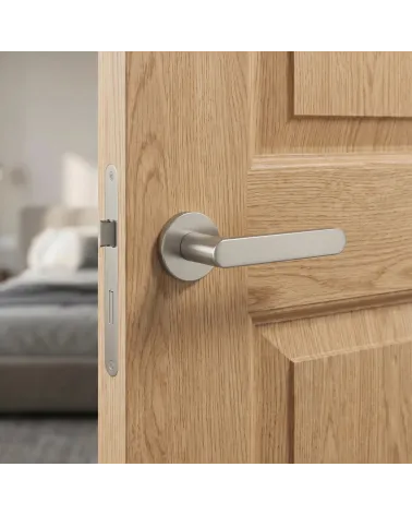 Décoration intérieure poignée de porte nickel design sur rosace ronde