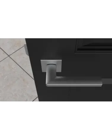 Poignée de porte chrome satiné PYROLA quincaillerie design vue de haut montée sur une porte