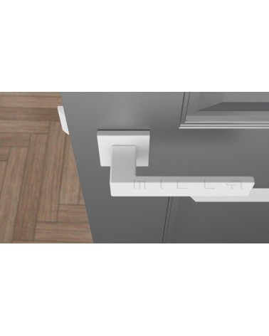 Poignée de porte blanche PINA poignée design vue de haut montée sur une porte