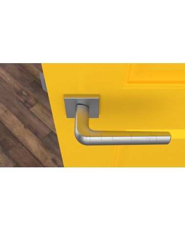 Poignée de porte en zamak MELA quincaillerie design couleur 2 vue de haut montée sur une porte