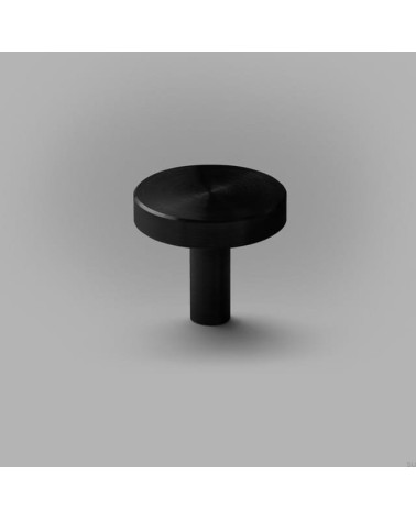 Bouton de meuble noire NENA M poignée design posée sur une surface plane