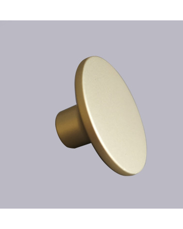 Bouton de meuble or mat ASTRO poignée design sur fond gris