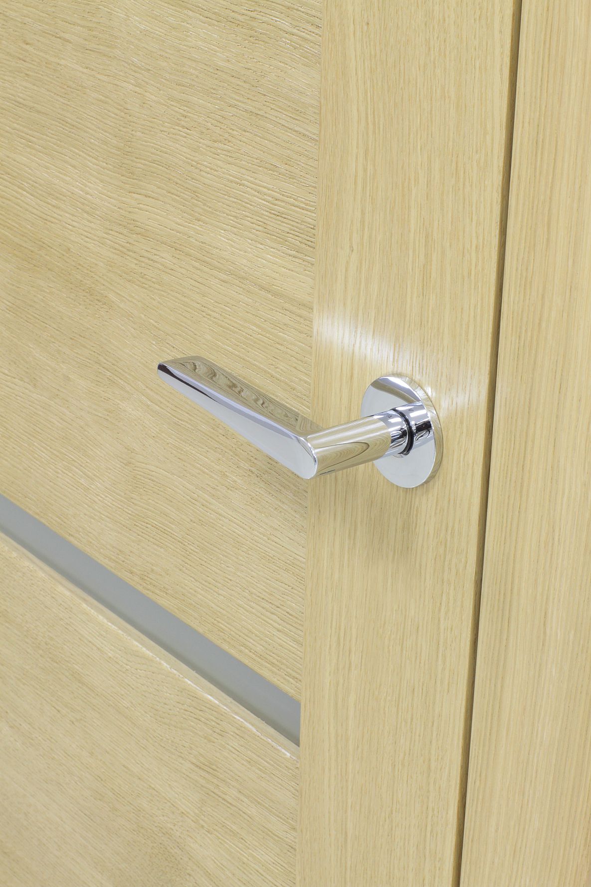 Chrome interior door handle on a light wood door