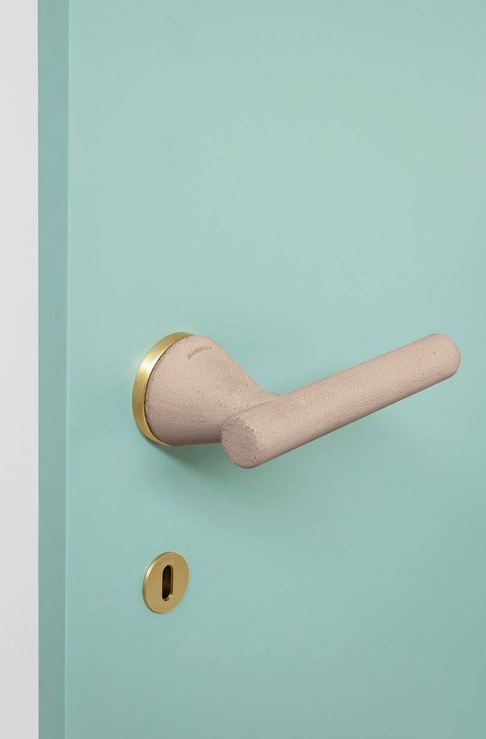 Original and atypical door handle made from concrete by Mandelli — a highly design and on-trend handle that combines minimalism with its ultra-slim bedroom key rosette