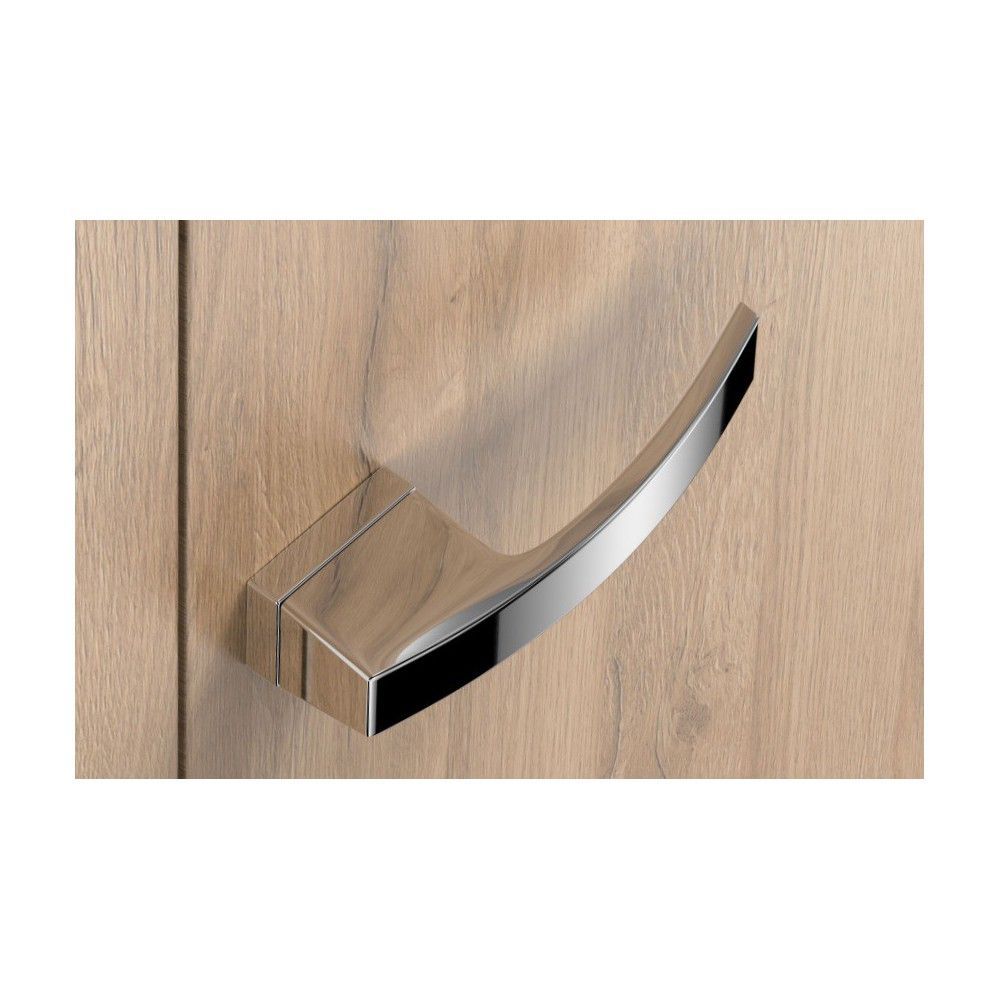 Chrome door handles on a light wood door from Milla Poignées
