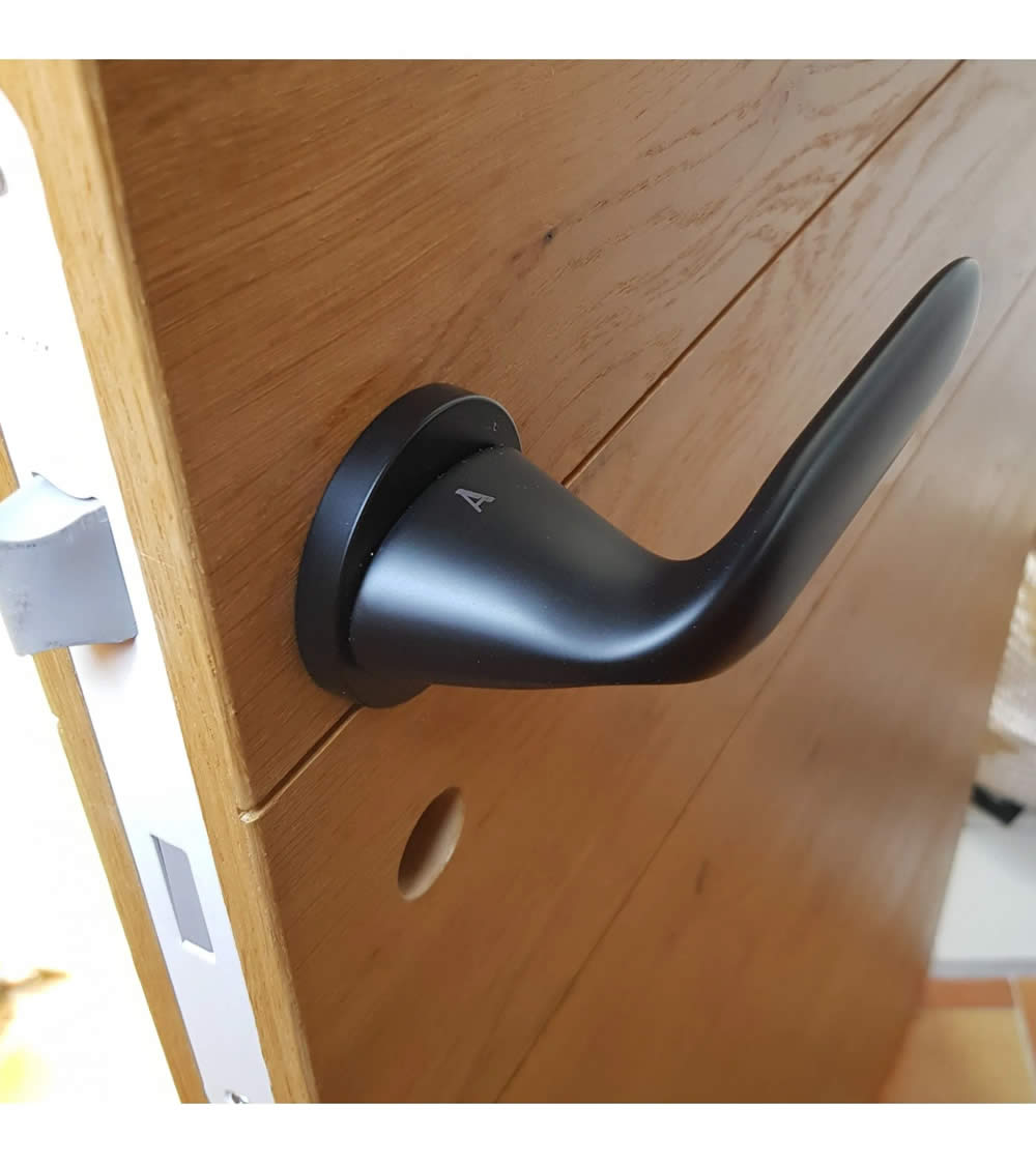 black door handle in the shape of a water droplet